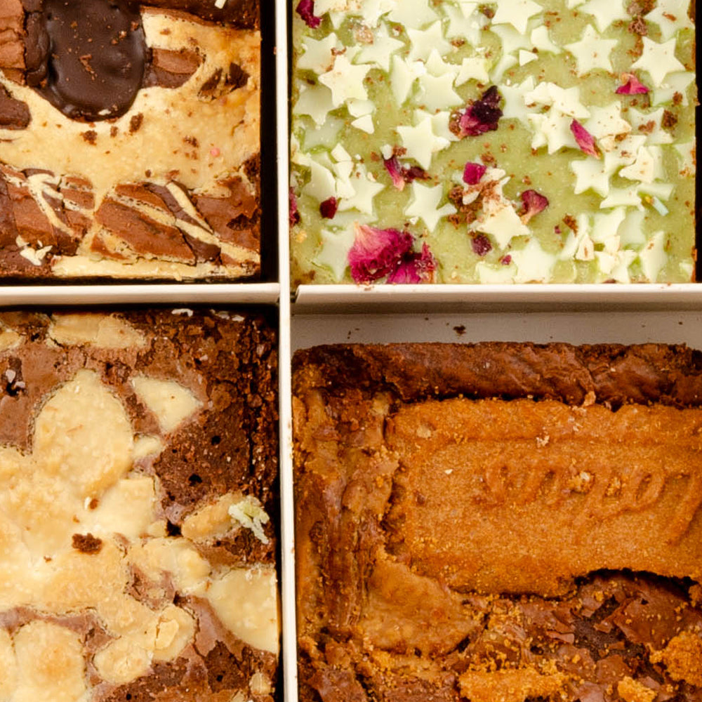 Close-up of a assorted brownie topped with lotus biscuit and sprinkles